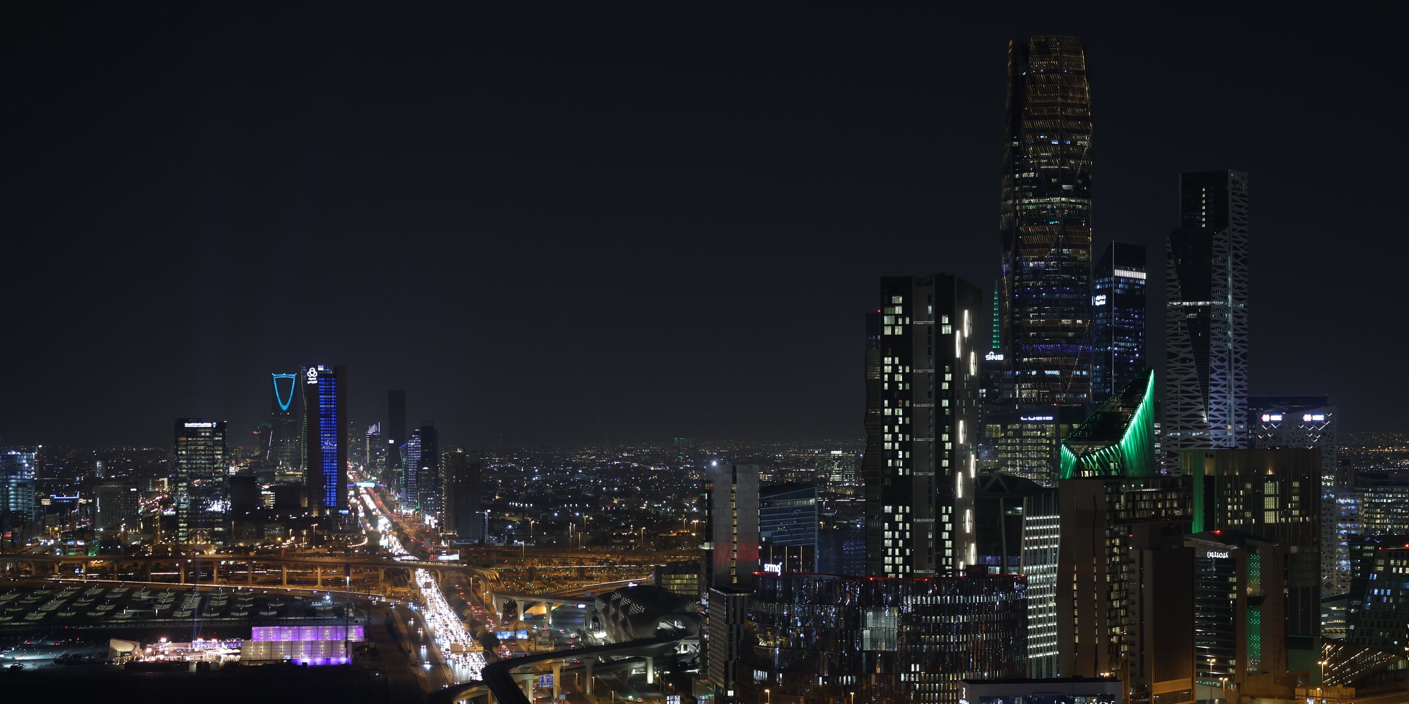 Night view of multiple towers in King Abdullah Financial District, Riyadh, Saudi Arabia